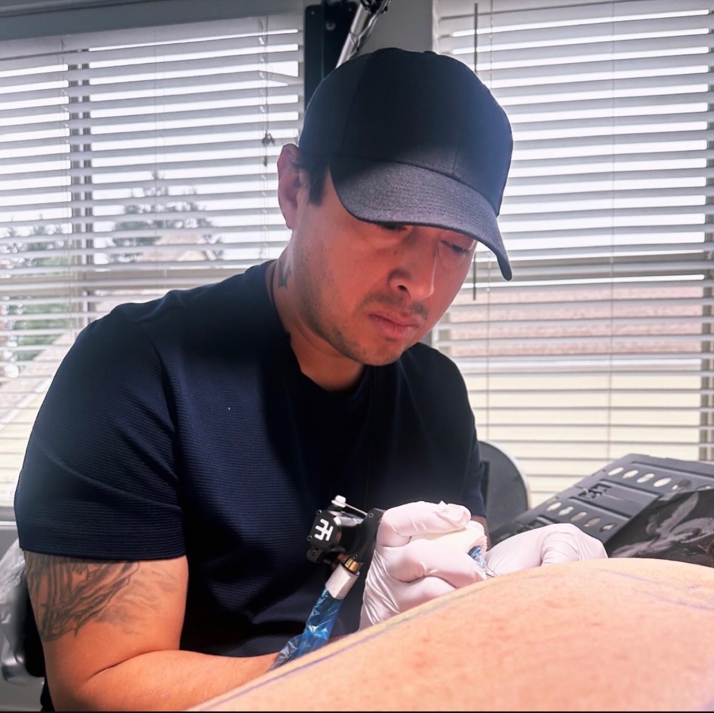 Tony Raz tattooing in the Renton studio