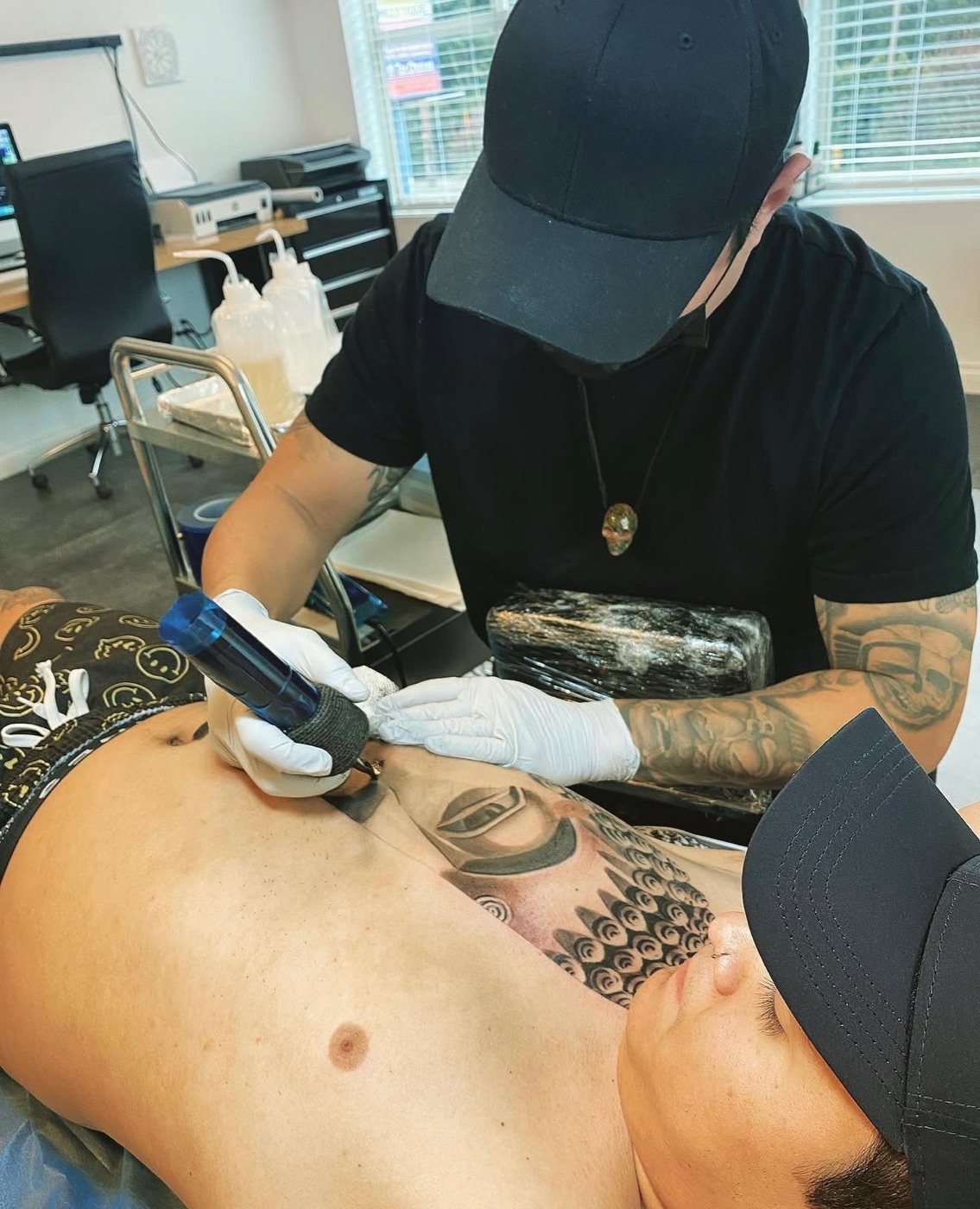 Tony Raz tattooing in the Renton studio